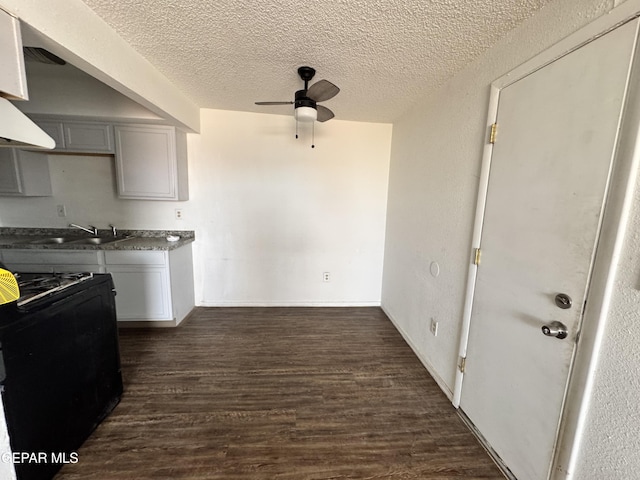 10620 Cuatro Vistas Dr Unit A, El Paso, TX 79935 - kitchen with black gas stove, a sink, ceiling fan, a textured ceiling, and dark wood finished floors