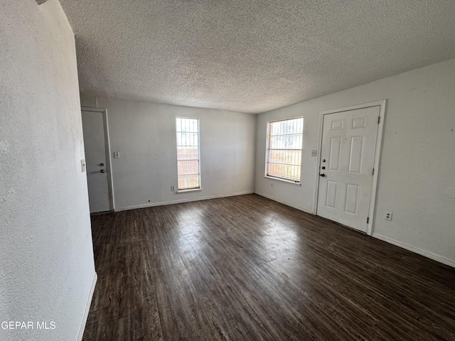 10620 Cuatro Vistas Dr Unit A, El Paso, TX 79935 - entrance foyer with wood finished floors, a textured ceiling, and baseboards