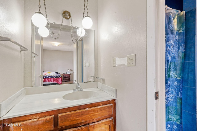 bathroom with vanity and a textured wall
