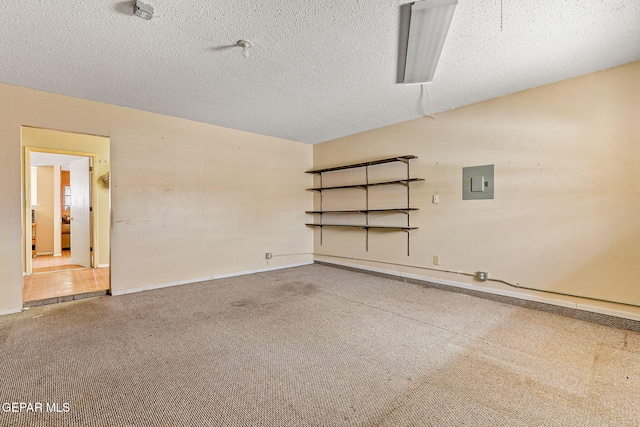 garage featuring baseboards and electric panel