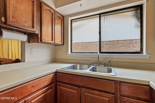 kitchen with light countertops, healthy amount of natural light, and brown cabinets
