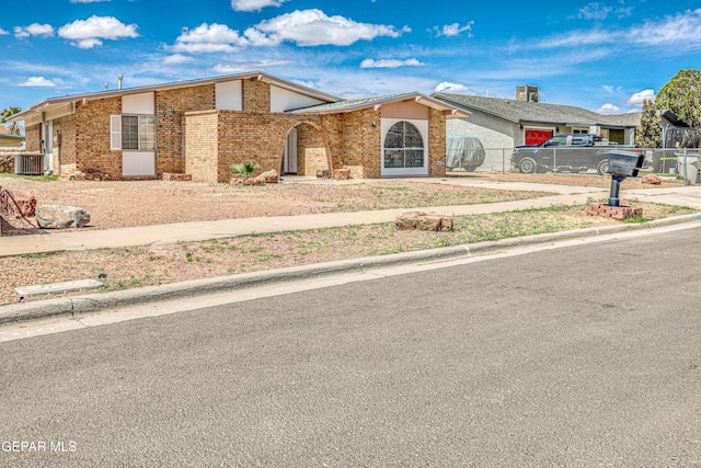 8520 Paddlefoot Ln, El Paso, TX 79907 - view of front facade featuring fence, brick siding, and central AC