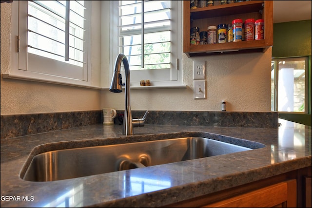 kitchen view of a sink and a textured wall