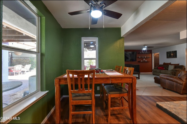 dining area featuring a ceiling fan and tile patterned flooring