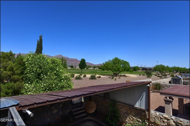 view of home's exterior featuring a mountain view, stone siding, and metal roof