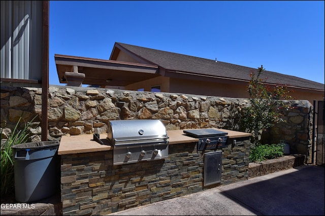 view of patio featuring a grill and exterior kitchen