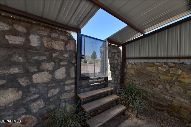 entrance to property featuring stone siding
