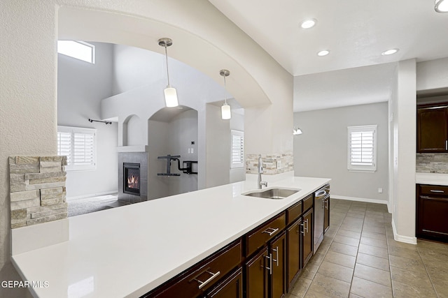 3136 Hawk Point Pl, El Paso, TX 79938 - kitchen with a sink, decorative backsplash, light countertops, stainless steel dishwasher, and decorative light fixtures