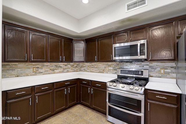 3136 Hawk Point Pl, El Paso, TX 79938 - kitchen featuring appliances with stainless steel finishes, dark brown cabinetry, light countertops, and recessed lighting