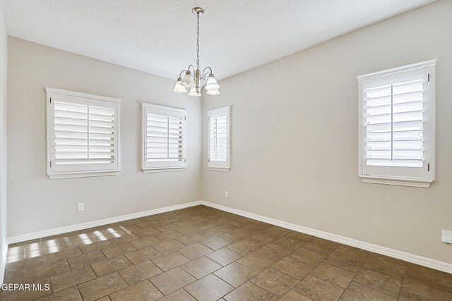 3136 Hawk Point Pl, El Paso, TX 79938 - unfurnished room with a chandelier and baseboards