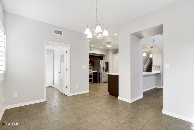 3136 Hawk Point Pl, El Paso, TX 79938 - unfurnished dining area with a chandelier, recessed lighting, arched walkways, baseboards, and stone tile floors