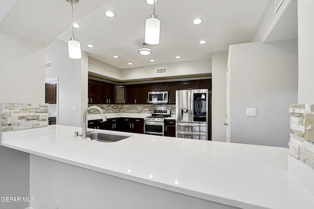 3136 Hawk Point Pl, El Paso, TX 79938 - kitchen featuring stainless steel appliances, a sink, backsplash, decorative light fixtures, and recessed lighting