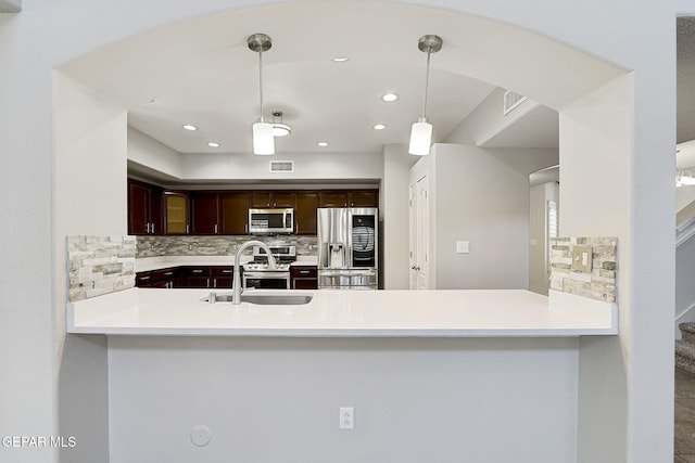 3136 Hawk Point Pl, El Paso, TX 79938 - kitchen with appliances with stainless steel finishes, backsplash, a sink, light countertops, and dark brown cabinets