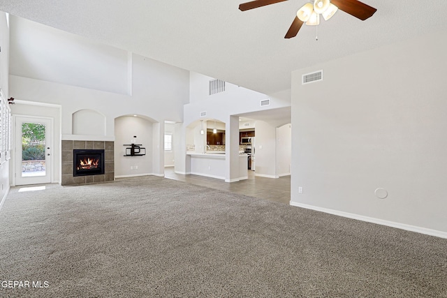 3136 Hawk Point Pl, El Paso, TX 79938 - unfurnished living room with carpet, ceiling fan, baseboards, and a tile fireplace