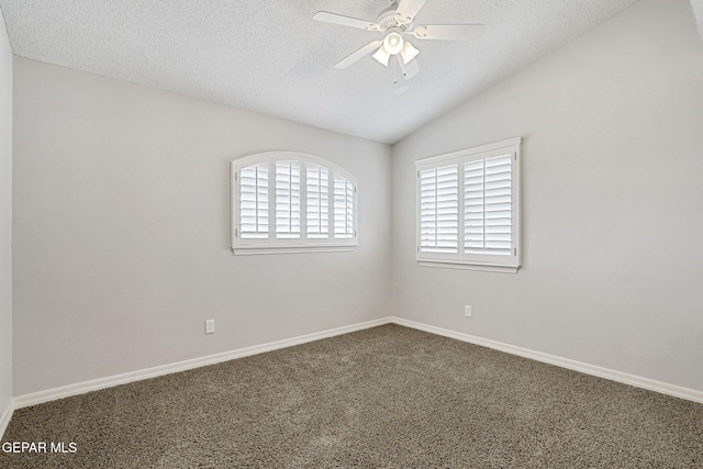 3136 Hawk Point Pl, El Paso, TX 79938 - spare room with dark carpet, a ceiling fan, a textured ceiling, vaulted ceiling, and baseboards