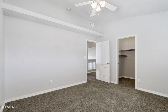 3136 Hawk Point Pl, El Paso, TX 79938 - unfurnished bedroom featuring carpet flooring, baseboards, a walk in closet, vaulted ceiling, and a ceiling fan