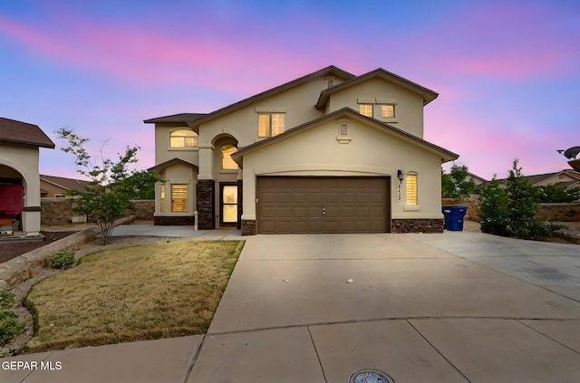 3136 Hawk Point Pl, El Paso, TX 79938 - view of front of home featuring stone siding, stucco siding, driveway, and an attached garage