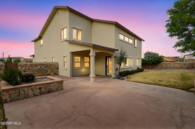 3136 Hawk Point Pl, El Paso, TX 79938 - back of house at dusk with a patio area, stucco siding, and fence