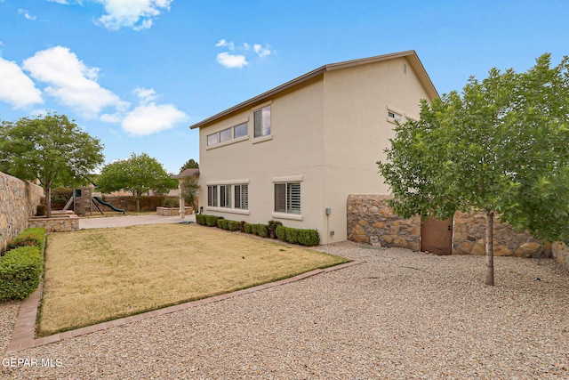 3136 Hawk Point Pl, El Paso, TX 79938 - back of property featuring a playground, stucco siding, and a patio