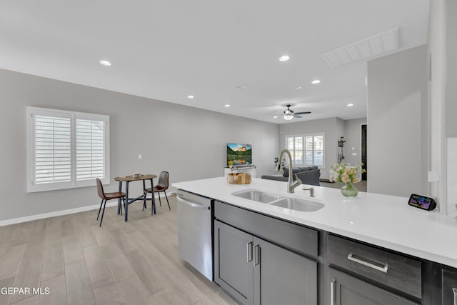 kitchen with a sink, stainless steel dishwasher, light countertops, ceiling fan, and recessed lighting