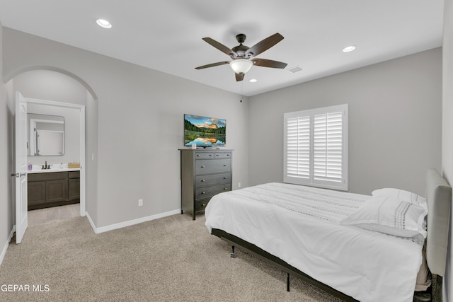 bedroom featuring baseboards, light carpet, recessed lighting, arched walkways, and ceiling fan