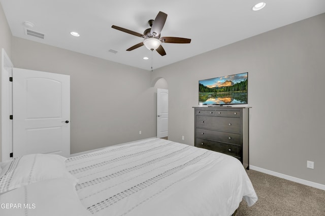 carpeted bedroom with recessed lighting, a ceiling fan, baseboards, and arched walkways