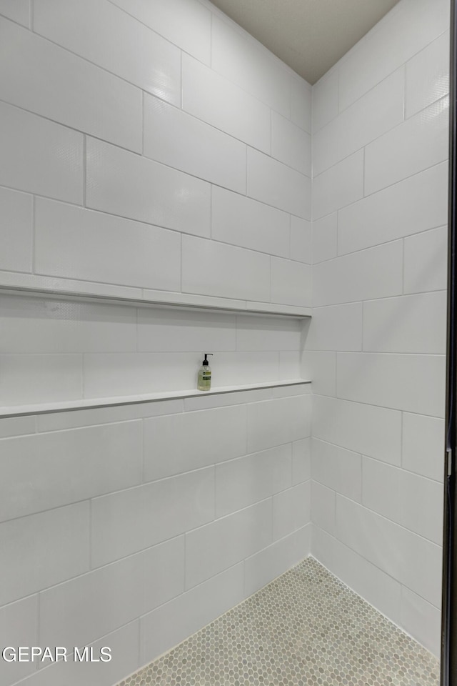 bathroom with a tile shower