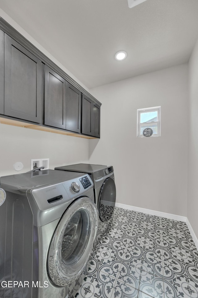 laundry area featuring cabinet space, washing machine and clothes dryer, baseboards, recessed lighting, and tile patterned floors