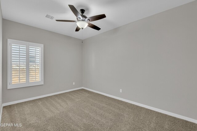empty room with ceiling fan, carpet flooring, and baseboards