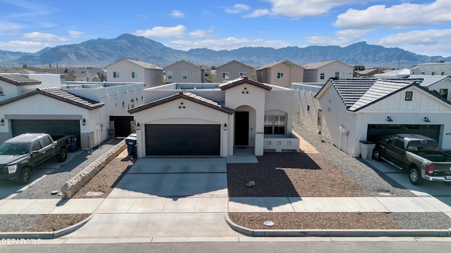 mediterranean / spanish-style home with a mountain view, a garage, and a residential view