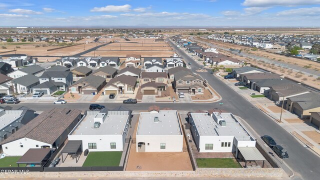 aerial view of property and surrounding area featuring nearby suburban area
