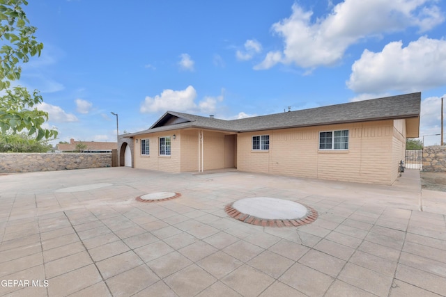 589 Gallagher St, El Paso, TX 79915 - back of property featuring a patio, brick siding, and fence