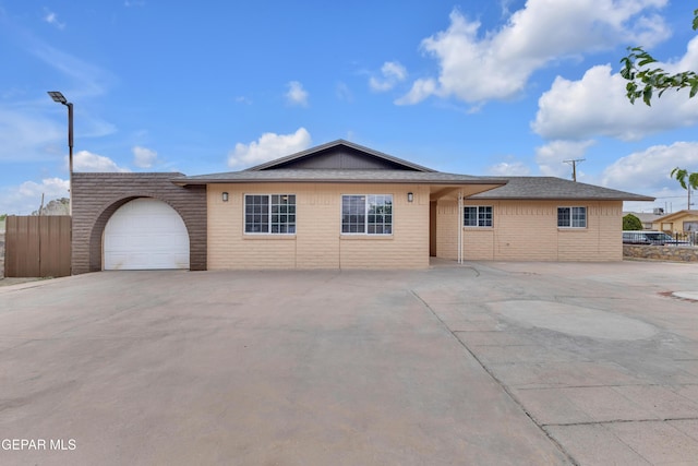 589 Gallagher St, El Paso, TX 79915 - ranch-style home featuring brick siding, a garage, fence, driveway, and roof with shingles