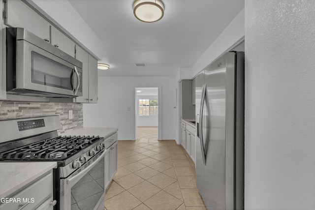 589 Gallagher St, El Paso, TX 79915 - kitchen featuring appliances with stainless steel finishes, tasteful backsplash, light countertops, light tile patterned floors, and baseboards