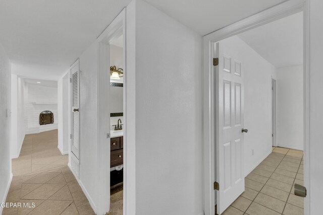 589 Gallagher St, El Paso, TX 79915 - hall featuring light tile patterned floors, a sink, and baseboards
