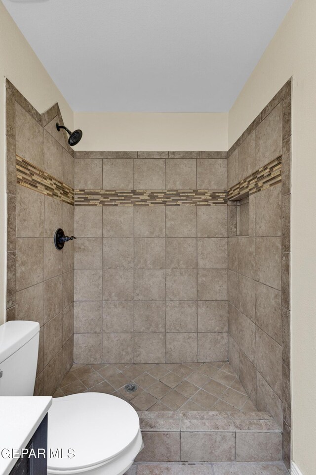 589 Gallagher St, El Paso, TX 79915 - bathroom featuring vanity, toilet, and a tile shower