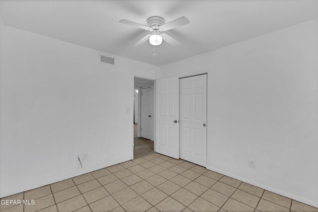 589 Gallagher St, El Paso, TX 79915 - unfurnished bedroom featuring light tile patterned floors, a closet, baseboards, and ceiling fan