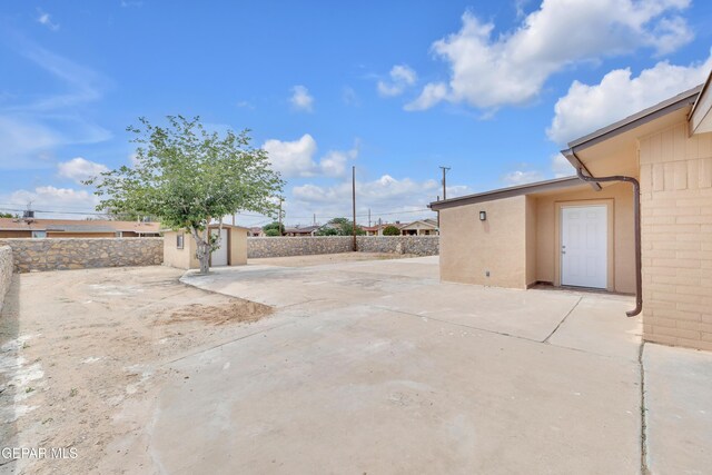 589 Gallagher St, El Paso, TX 79915 - view of patio / terrace with a storage unit, an outdoor structure, and a fenced backyard