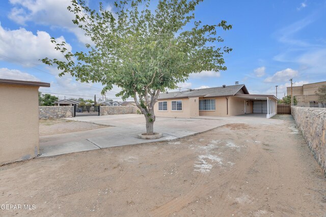 589 Gallagher St, El Paso, TX 79915 - back of house featuring fence, driveway, and a carport