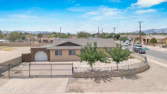 589 Gallagher St, El Paso, TX 79915 - view of front facade with a fenced front yard, a mountain view, driveway, and a shingled roof