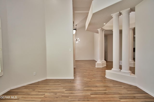1483 Via Appia St, El Paso, TX 79912 - unfurnished room featuring light wood finished floors, decorative columns, and baseboards
