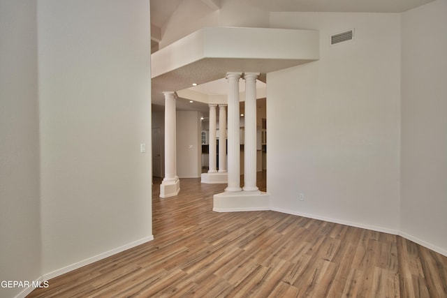 1483 Via Appia St, El Paso, TX 79912 - spare room featuring decorative columns, wood finished floors, and baseboards