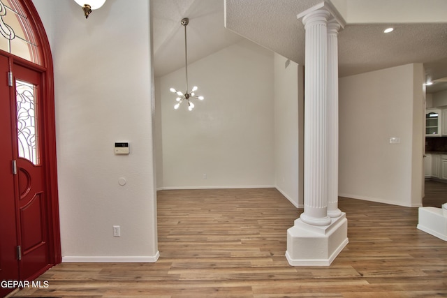 1483 Via Appia St, El Paso, TX 79912 - foyer entrance with decorative columns, wood finished floors, high vaulted ceiling, baseboards, and recessed lighting