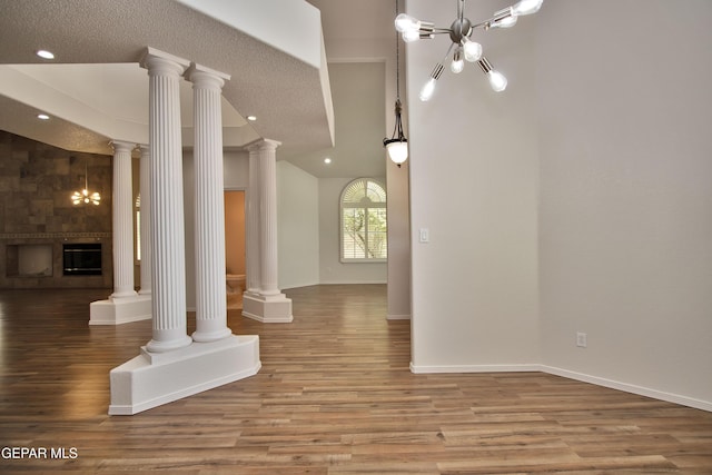 1483 Via Appia St, El Paso, TX 79912 - unfurnished living room featuring wood finished floors, recessed lighting, baseboards, and ornate columns