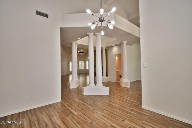 1483 Via Appia St, El Paso, TX 79912 - unfurnished room featuring light wood-style floors, decorative columns, a chandelier, baseboards, and recessed lighting