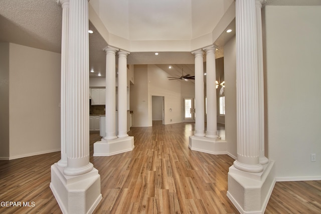 1483 Via Appia St, El Paso, TX 79912 - corridor featuring ornate columns, light wood-type flooring, recessed lighting, baseboards, and lofted ceiling