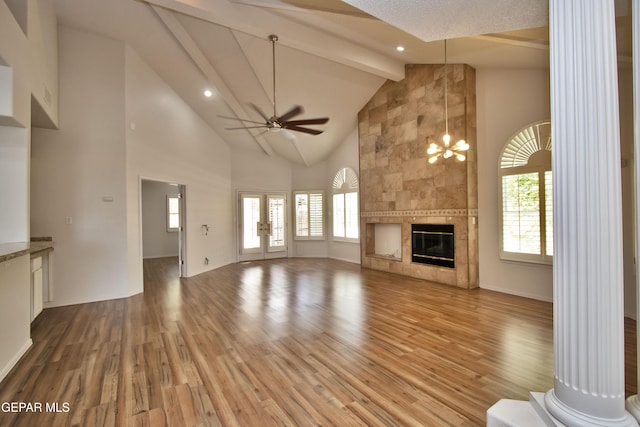1483 Via Appia St, El Paso, TX 79912 - unfurnished living room featuring ceiling fan, light wood finished floors, high vaulted ceiling, plenty of natural light, and beam ceiling