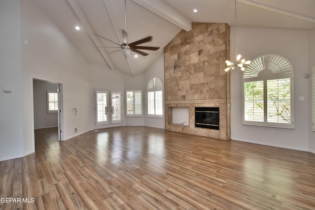 1483 Via Appia St, El Paso, TX 79912 - unfurnished living room featuring a ceiling fan, plenty of natural light, light wood-style floors, high vaulted ceiling, and beamed ceiling