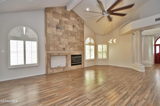 1483 Via Appia St, El Paso, TX 79912 - unfurnished living room featuring ornate columns, a ceiling fan, beamed ceiling, a fireplace, and wood finished floors