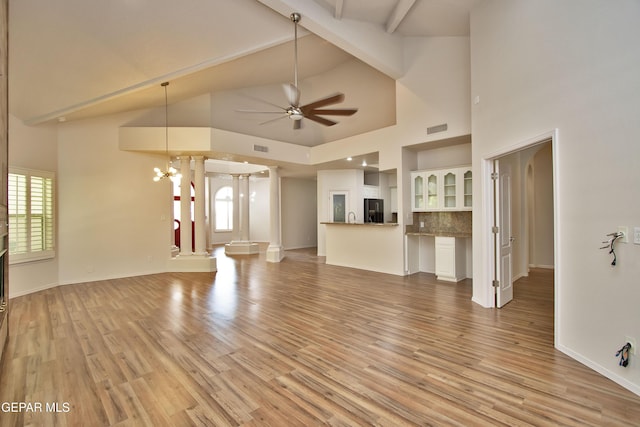 1483 Via Appia St, El Paso, TX 79912 - unfurnished living room with healthy amount of natural light, a ceiling fan, light wood-type flooring, high vaulted ceiling, and beam ceiling